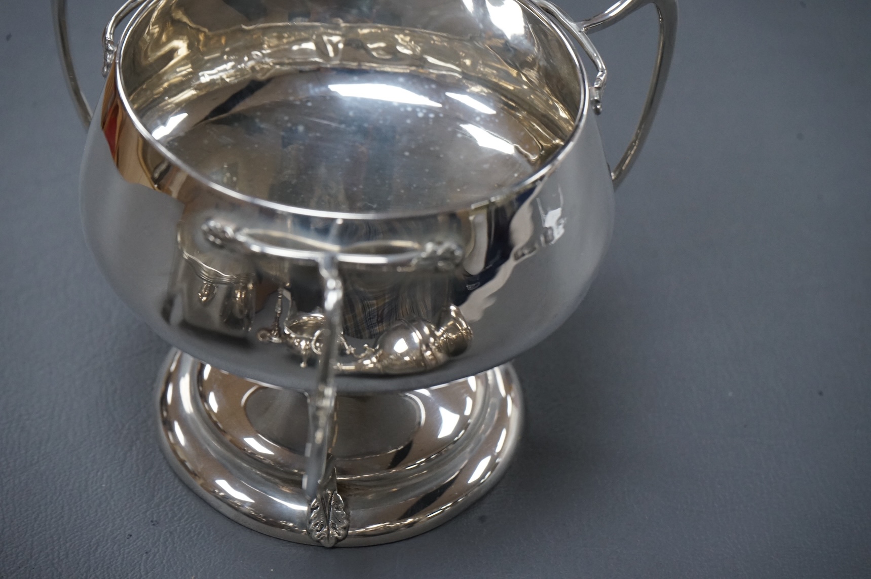 A collection of small silver including an Edwardian Art Nouveau tri-handled pedestal bowl, Birmingham, 1909, height 90mm, a sugar bowl, three cigarette cases, goblet, communion jug, five condiments, three napkin rings, e
